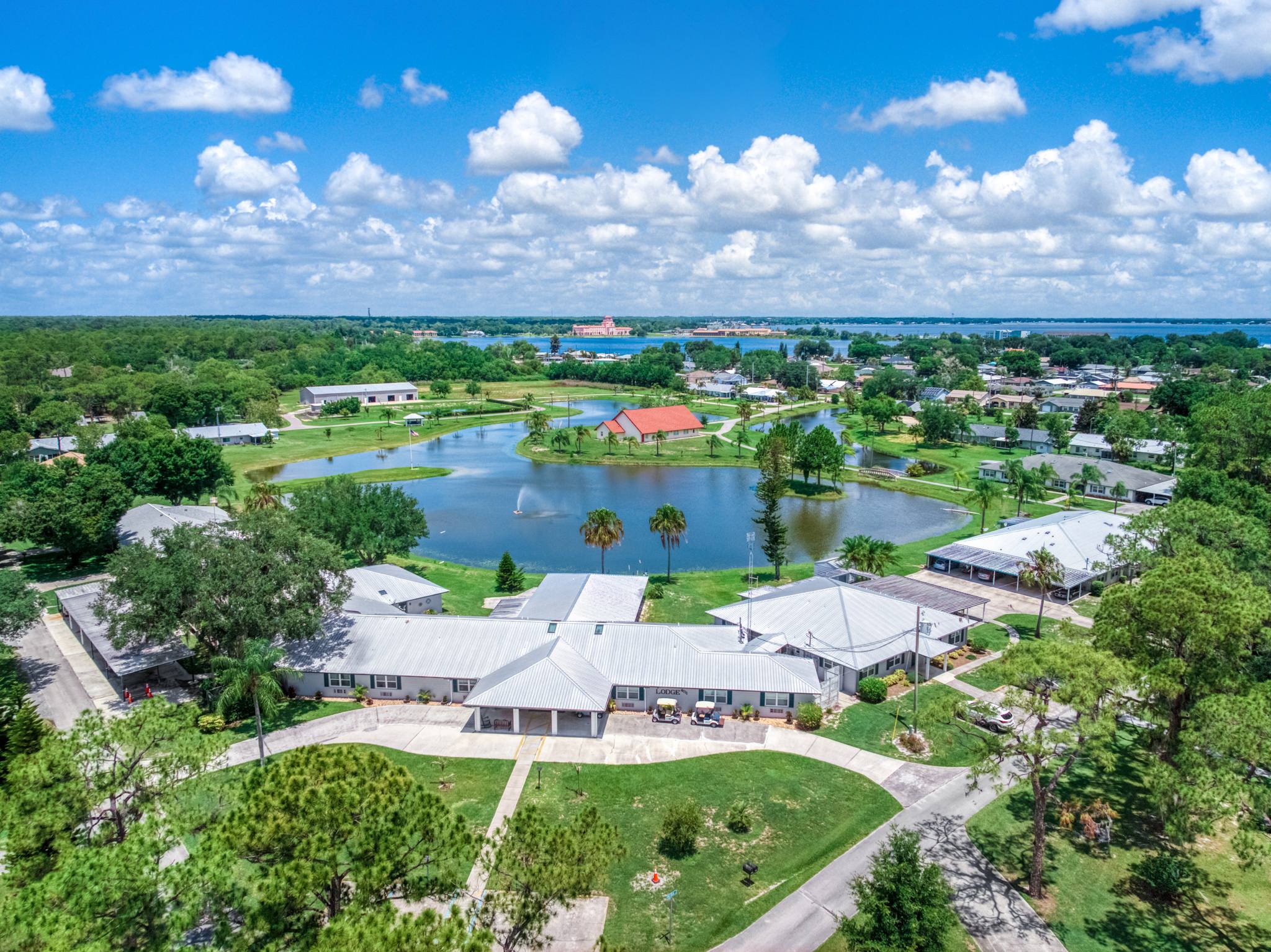 The Village lake with its fountain and the chapel on its peninsula, seen from above, with Lake Jackson beyond